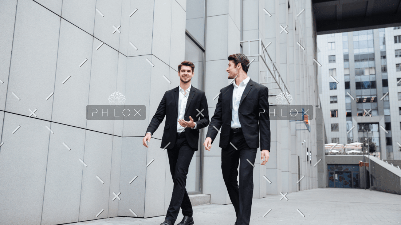 demo-attachment-922-two-businessmen-walking-and-talking-in-the-city-PMW8E26